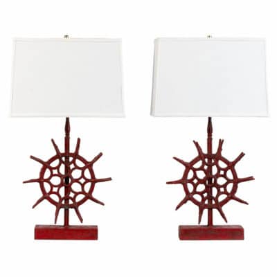 Close-up of two round spindle lamps with red metal bases, showcasing their vintage industrial design.