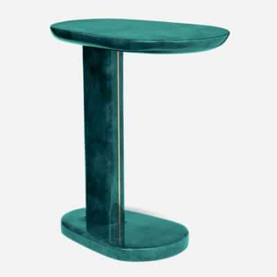 Close-up of teal velvet pedestal side table with brass inlay.