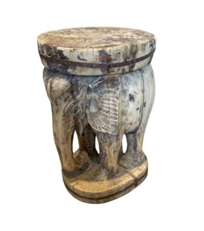 Carved wooden elephant stool, intricate design, unique piece.