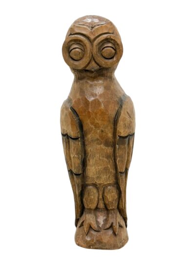 Side view of carved wooden owl sculpture, vintage rustic design.