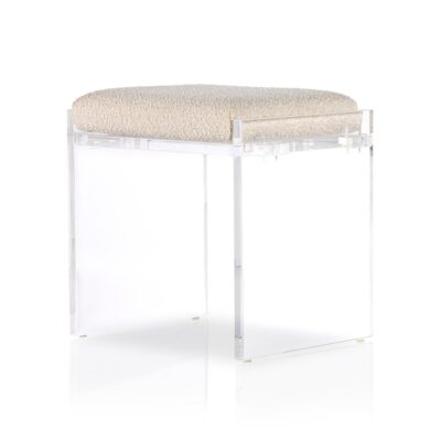 Stylish acrylic stool with plush boucle cushion in spotlight.