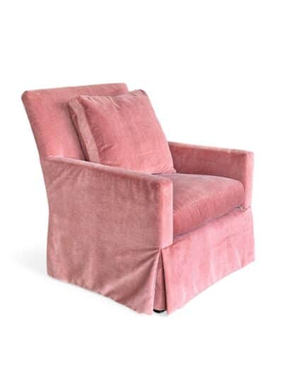 Armchair in russet velvet with skirted base.