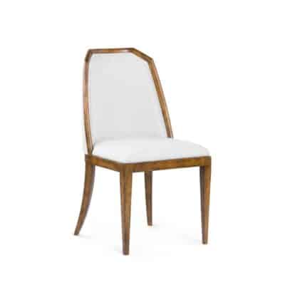 Modern dining chair with curved legs, faux shaved chenille upholstery in Midnight finish, and walnut stain.