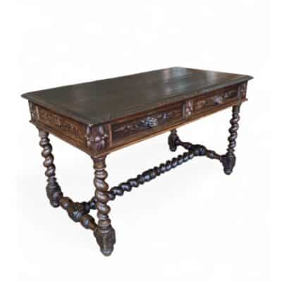 Front view of antique console table with intricate carvings and barley twist legs.