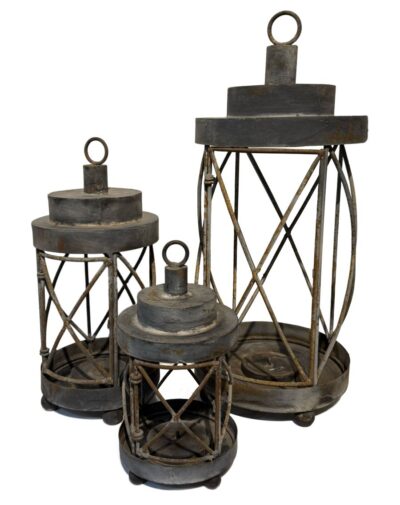 Close-up of antique French candle hurricane, featuring intricate ironwork and patina finish.