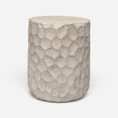 Close-up of grey stone stool with natural dimpled texture.