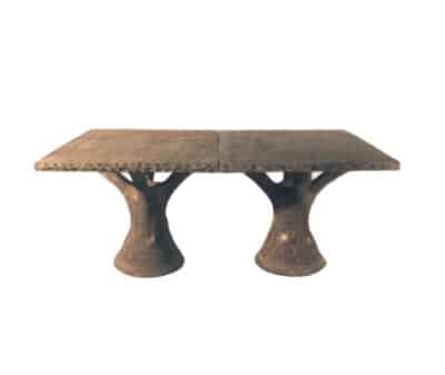 Outdoor dining table in faux bois finish, showcasing natural stone-like texture.
