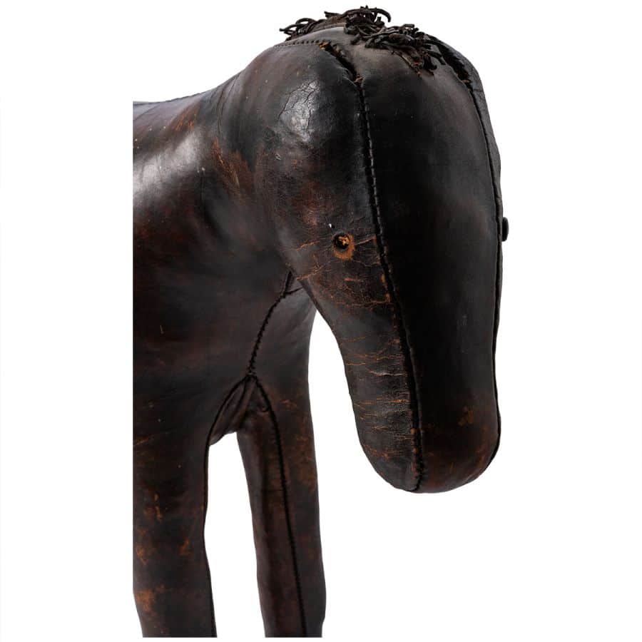 Close-up of Antique English Leather Horse Footstool showcasing aged leather texture and patina finish.