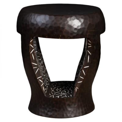 Close-up of wooden stool with intricate patterns on legs and seat, featuring dark brown hue with subtle lighter highlights.