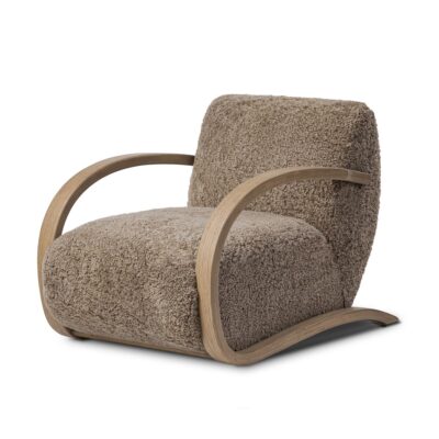 Close-up of Low Slung Shearling Chair, featuring luxurious taupe shearling seat atop a curved sandy oak veneer frame.