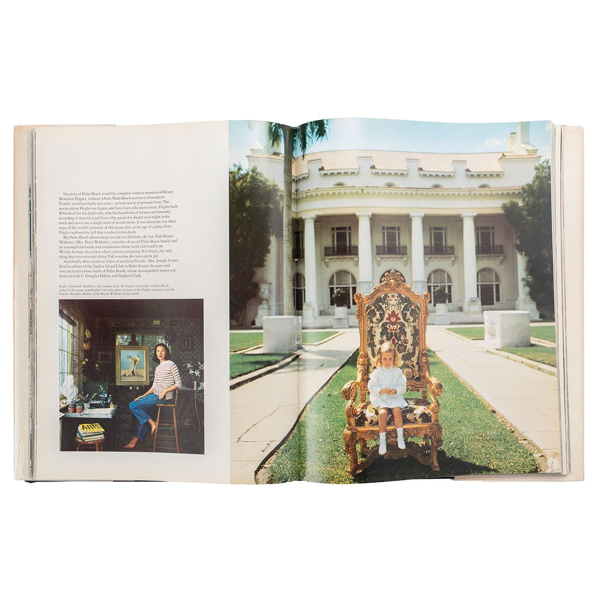 A child seated on an ornate chair in front of the White House.