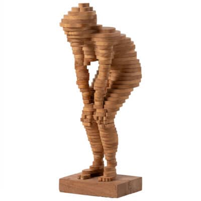 Close-up of vintage layered wood woman figure sculpture, intricate details in warm tones.