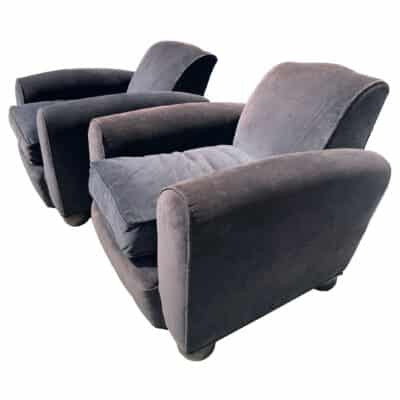 Close-up of vintage French chairs featuring dark stained wood bun footings and plush upholstery, circa 1950s.