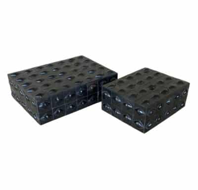 Close-up of black diamond boxes, elegant design, varying sizes, unique natural material appeal.
