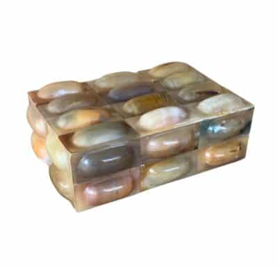 Shiny metallic box with intricate designs, showcasing natural horn material in various shades.