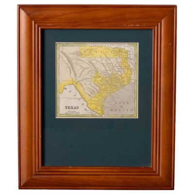 Close-up of framed vintage hand colored map of Texas, showcasing intricate details and historical territories.