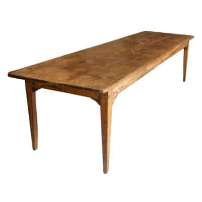 Close-up of Antique French Lindenwood Dining Farm Table with Aged Patina Four Plank Top on Simple Wooden Base.