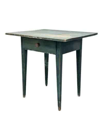 Close-up of antique blue wood table with distressed finish, showcasing early 19th century charm.