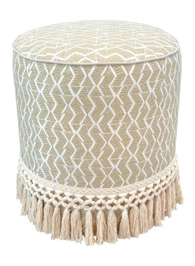 Drum-shaped ottoman in tesso suede with fringe detail, showcasing palm beach design.