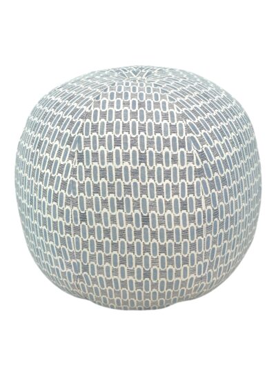 Close-up of round ottoman upholstered in sky blue Paloma fabric.