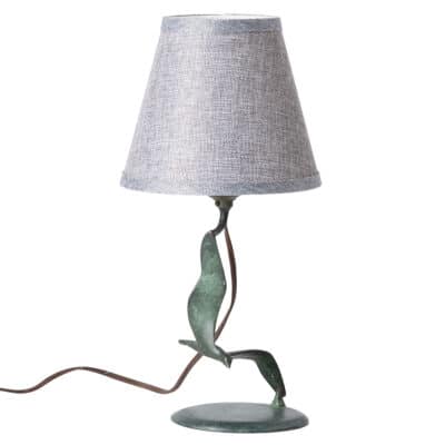 Close-up of vintage green tarnished metal "Bird in Flight" table lamp.
