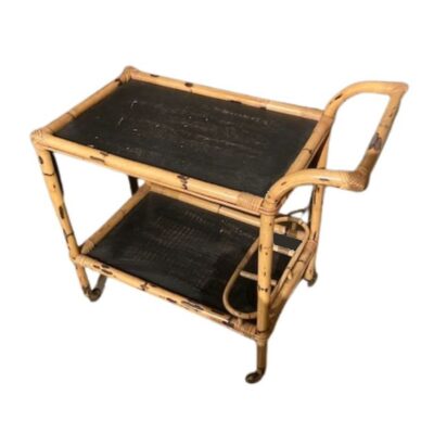 Front view of vintage French bamboo bar cart with black wooden shelves, circa 1960s.