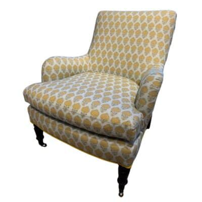 Marigold floral chair in vibrant yellow, featuring pecan finish legs and antique brass casters.