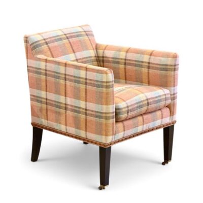 Close-up of Colgate Chair in apricot plaid fabric with natural nail trim pecan finish on legs highlighting its luxurious upholstery and elegant