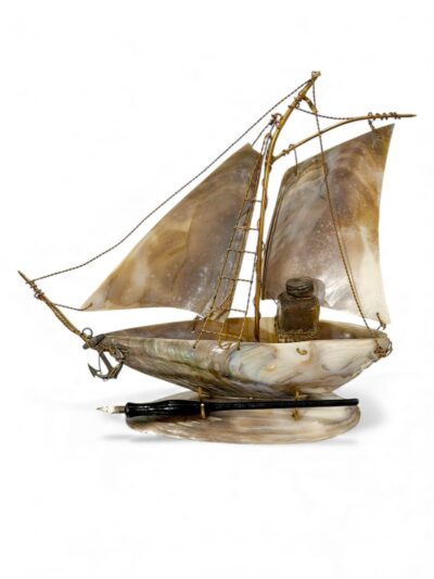 Close-up of vintage abalone ship ink and pen stand, intricate details highlight its charm.