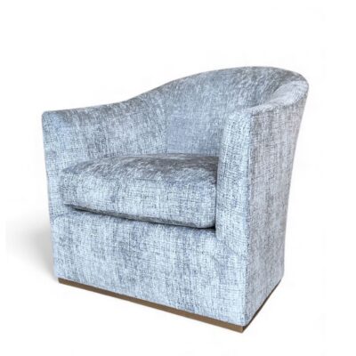 Close-up of Alexander Shadow Baltic Blue Swivel Chair, upholstered in plush fabric.