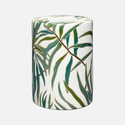 Close-up of Dorothy Ceramic Palm Motif Stool with vibrant green and blue foliage design.