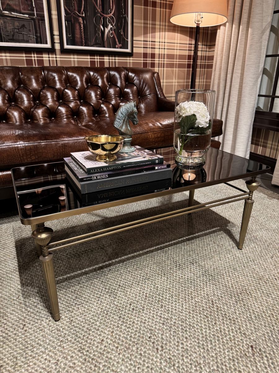 Close-up of Smoked Glass Coffee Table with Antiqued Brass Base, showcasing its elegant design in New York City.