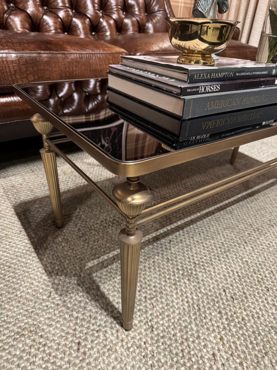 Close-up of Smoked Glass Coffee Table with Antiqued Brass Base showcasing its elegant design.