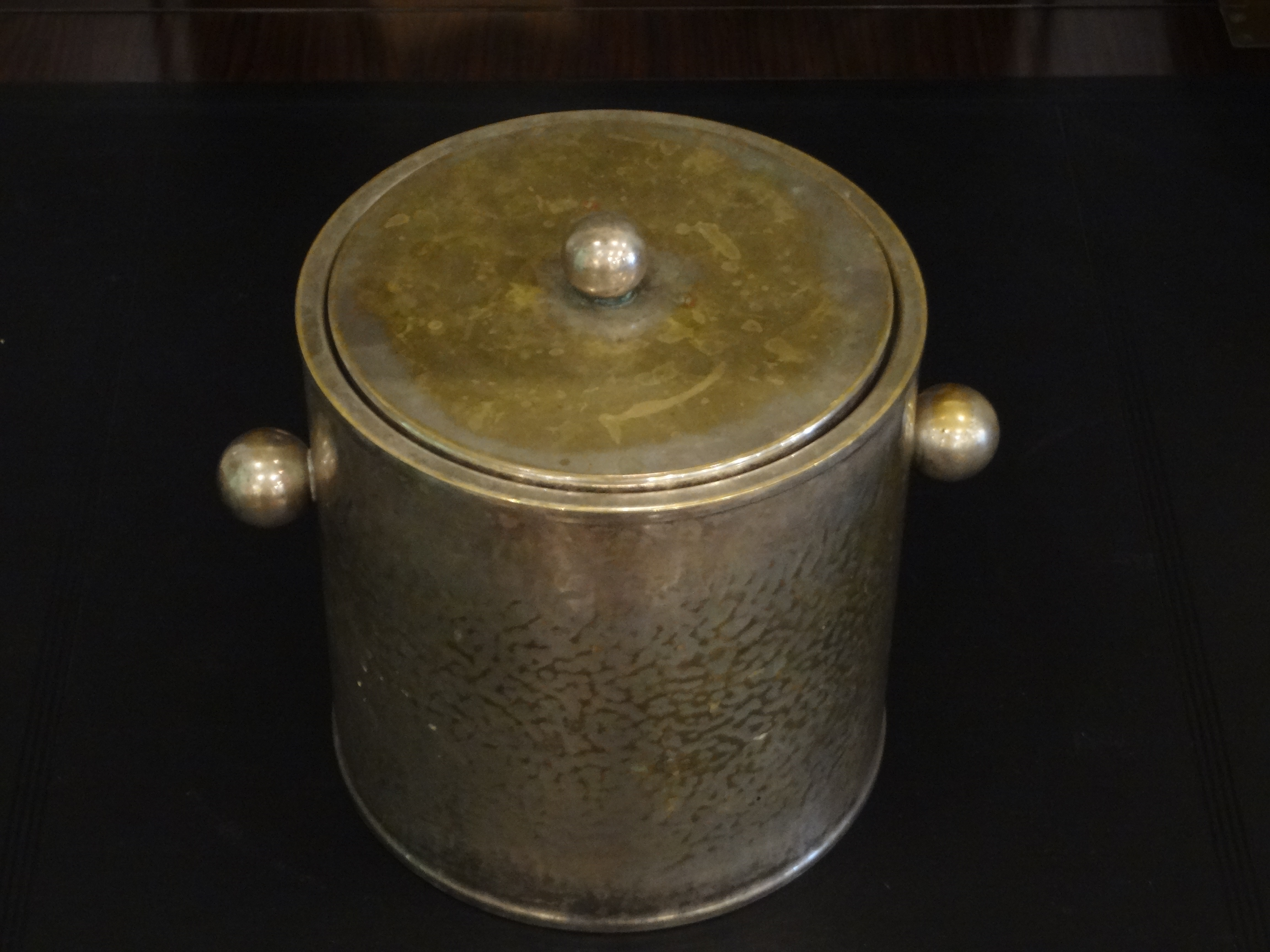 Vintage French "Christian Dior" silver ice bucket with hammered finish, placed on a table.