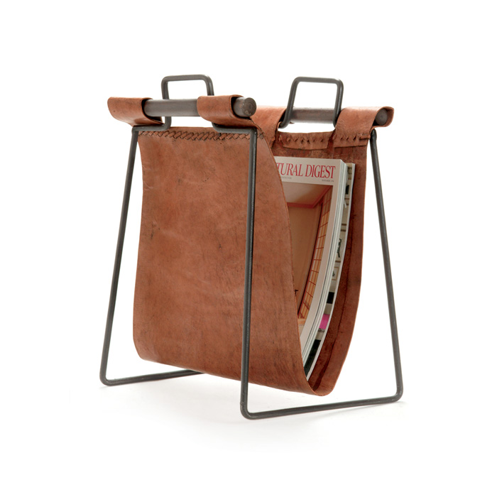 Iron and leather magazine rack with two openings, showcasing a book inside, on a white background.