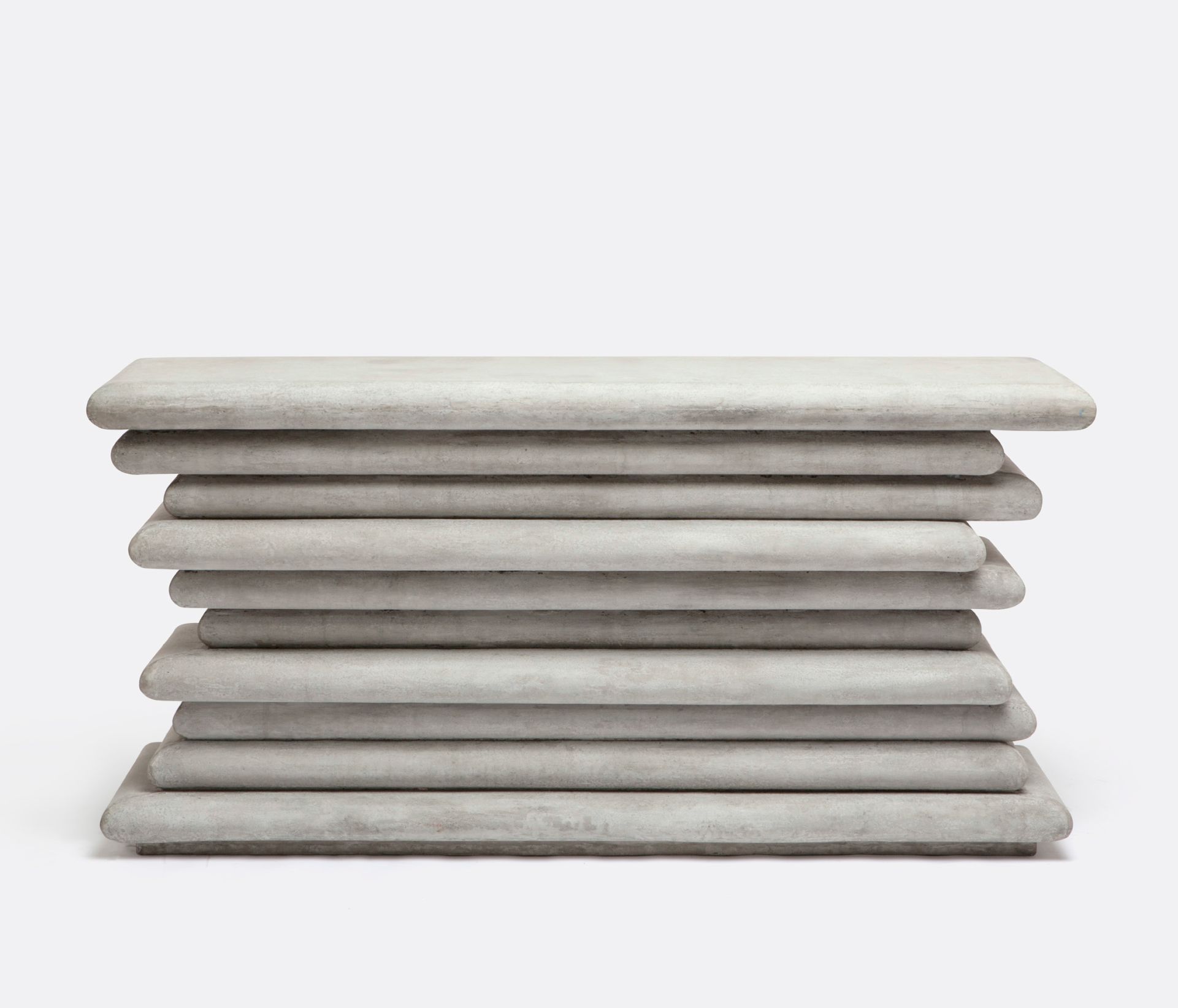 Stacked concrete console in light gray, with natural variations in color and minor cracks visible.