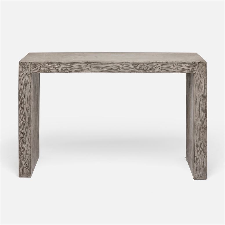 A large outdoor etched concrete parsons console table with a dark gray finish, standing against a white background.