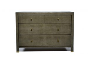 Dresser with four drawers, featuring a faux shagreen finish and brass hardware, displayed in a close-up view against a white background.
