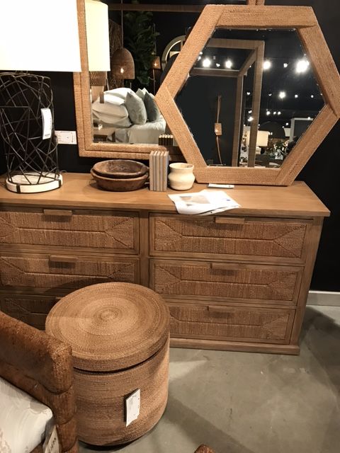 Brown wooden dresser with a rope design, featuring six drawers and hardwood handles, in a room with a dark background.