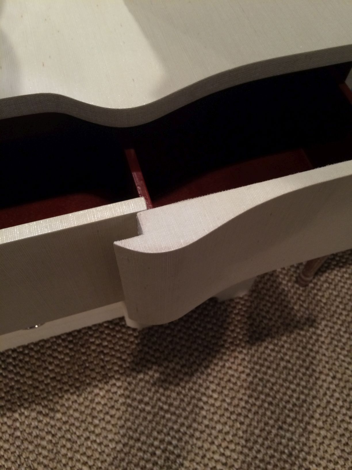 Large dresser with a curved front and silver ring pulls, showcasing its design and material.