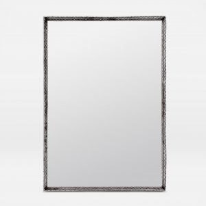 Metal mirror with a tramp art style, featuring an antiqued silver or polished brass frame, set against a white background.