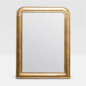 Gold framed mirror with a curved top and faux nailhead trim, set against a white background.