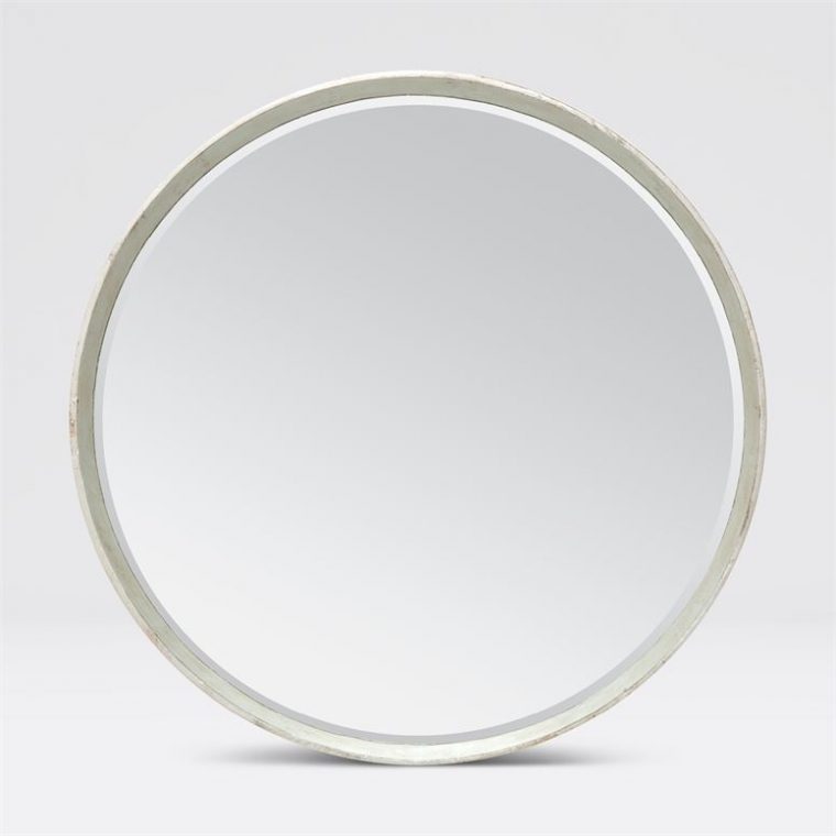 Round mirror with a silver frame and a white background.