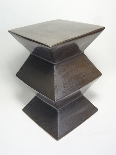 Ceramic zig zag garden stool with a unique texture and glaze pitting available in various colors including gunmetal blue white green light