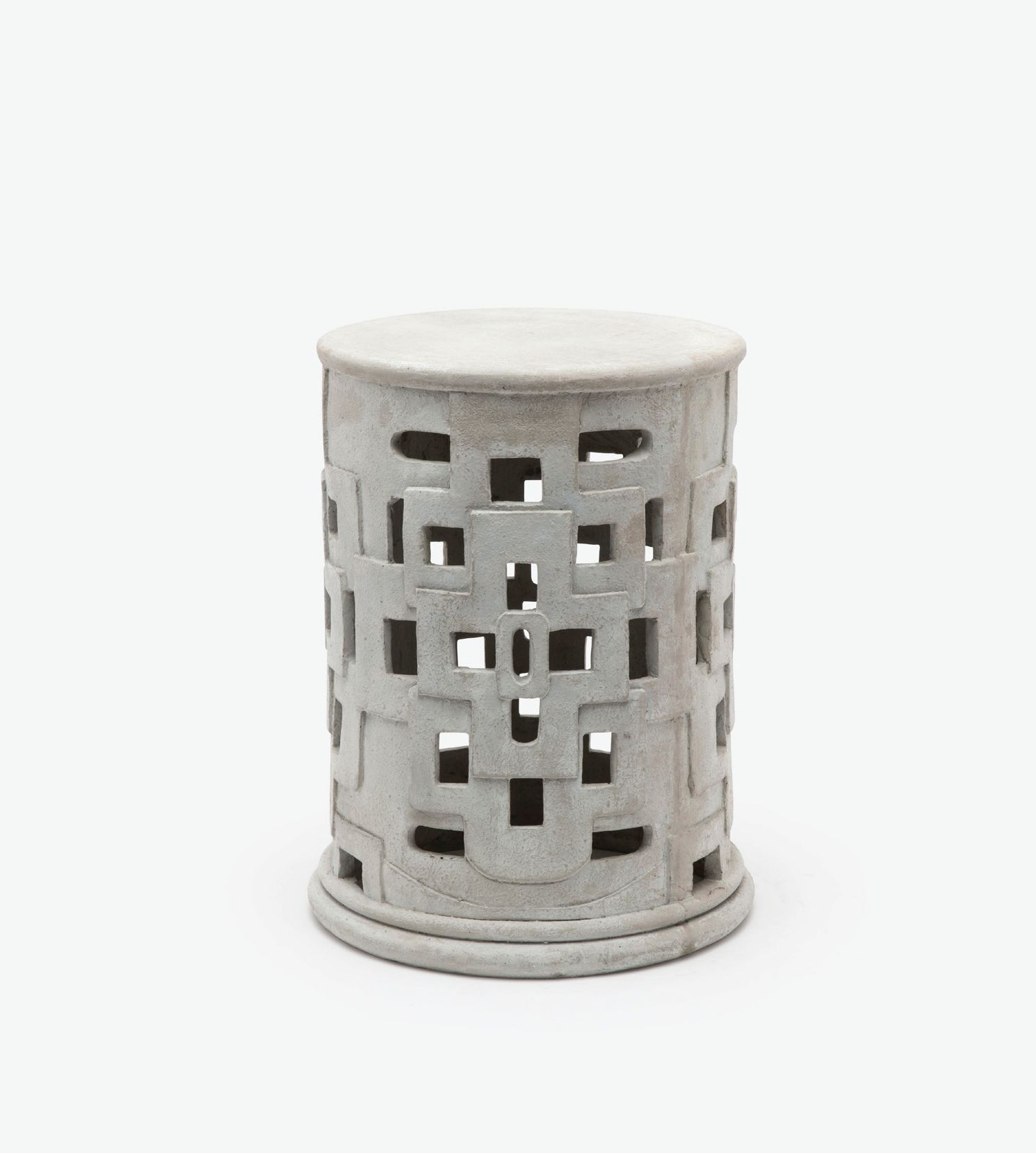 This image features a handcrafted outdoor patched cut out concrete stool with variation in size between pieces and minor cracks and imperfections