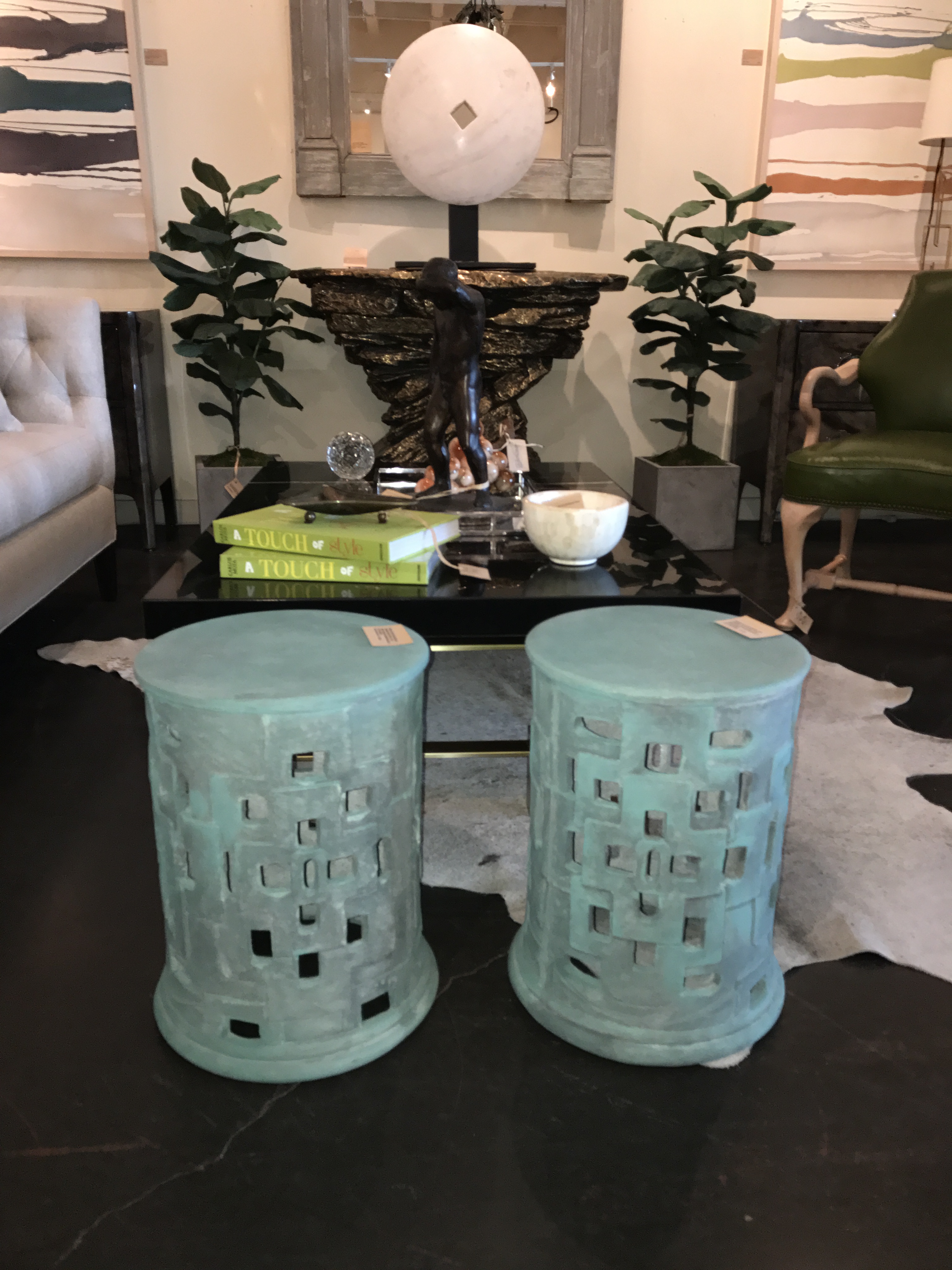 Two outdoor patched cut out concrete stools one light grey and one verdigris with minor cracks and imperfections available in two sizes