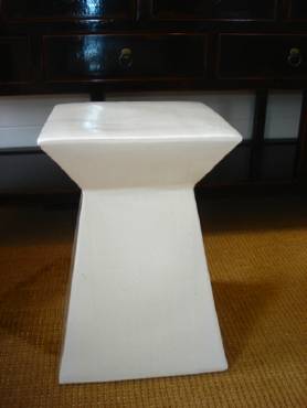 White abstract ceramic garden stool, hand fired and glazed with unique texture and pitting, outdoor furniture.