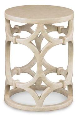 A beige side table with intricate carvings and a geometric design, showcasing its sturdy structure.